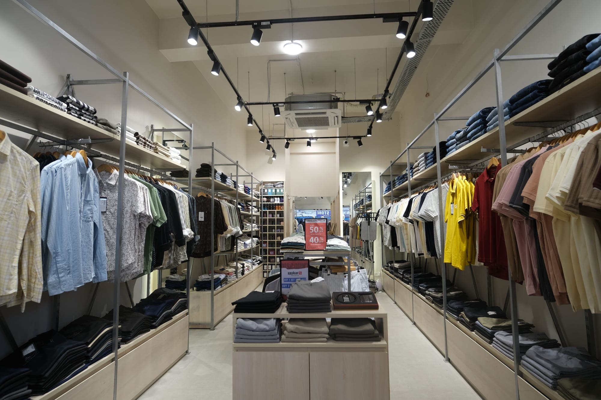 Urban Closet, Goalpara, from the entrance: shirts and denim either side of the centre table