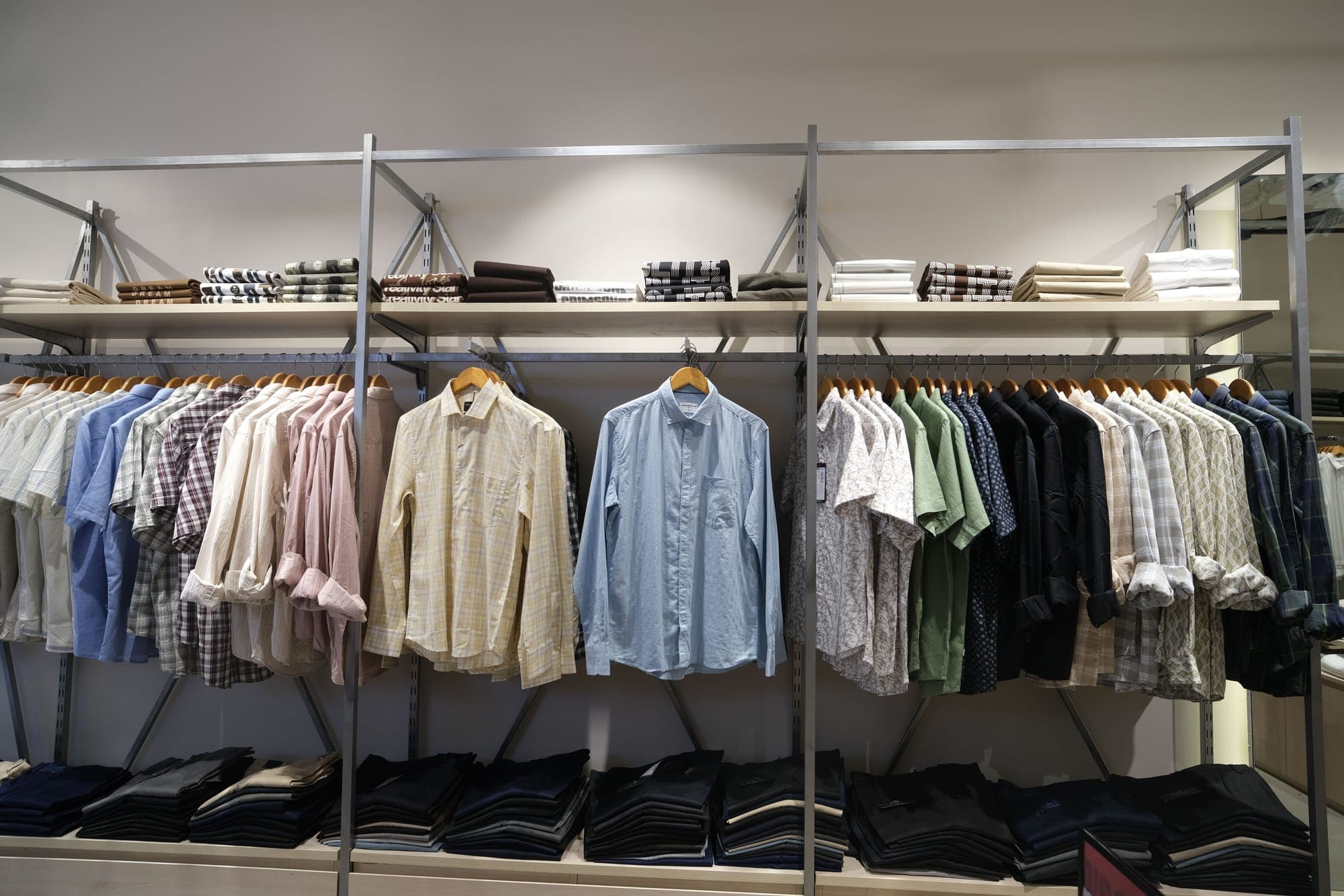 The shirt wall at Urban Closet, Goalpara, folded stock below the rail