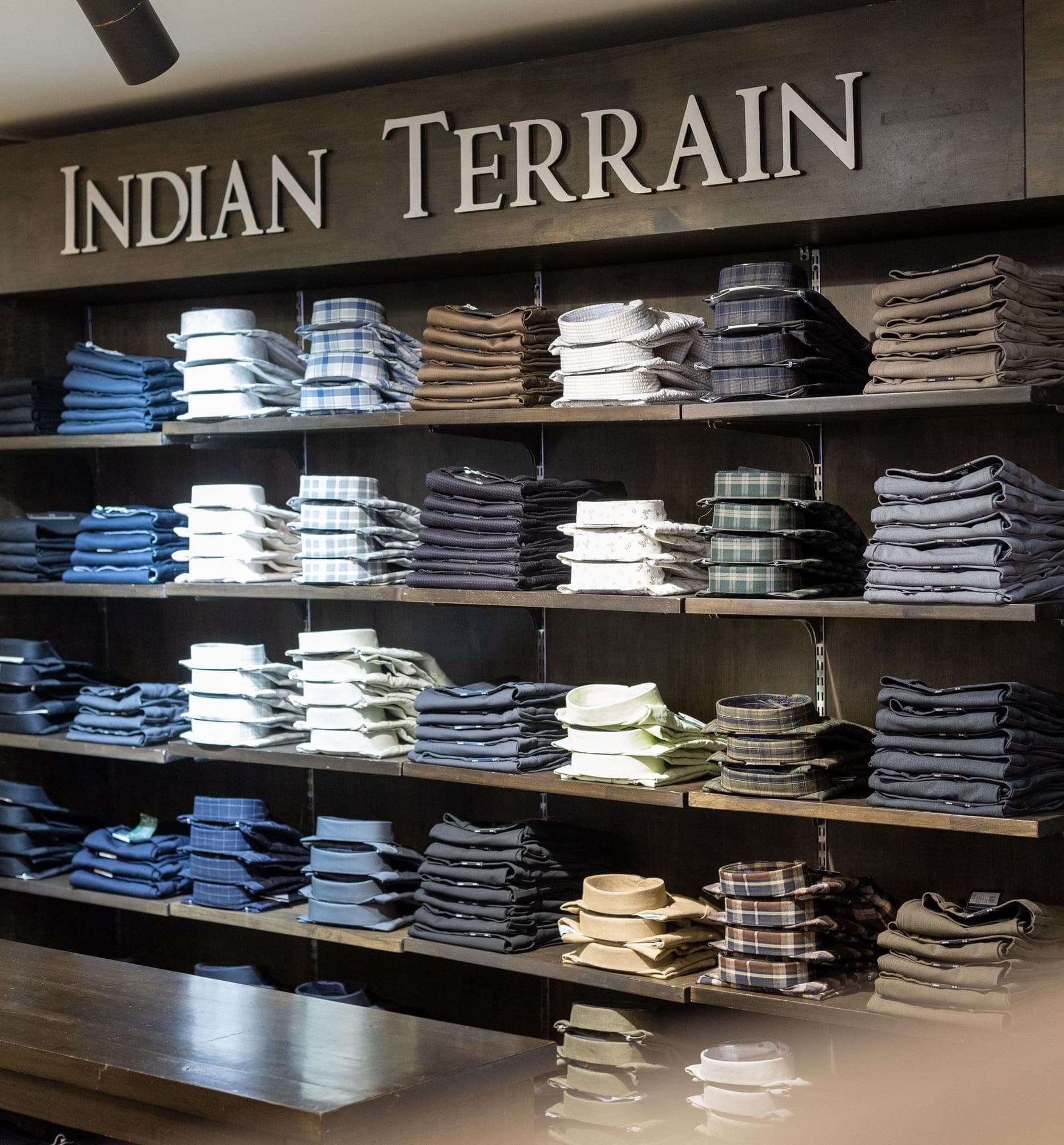 The Indian Terrain shelves at K.A.K, Kohima, folded shirts and trousers under the brand's lettering