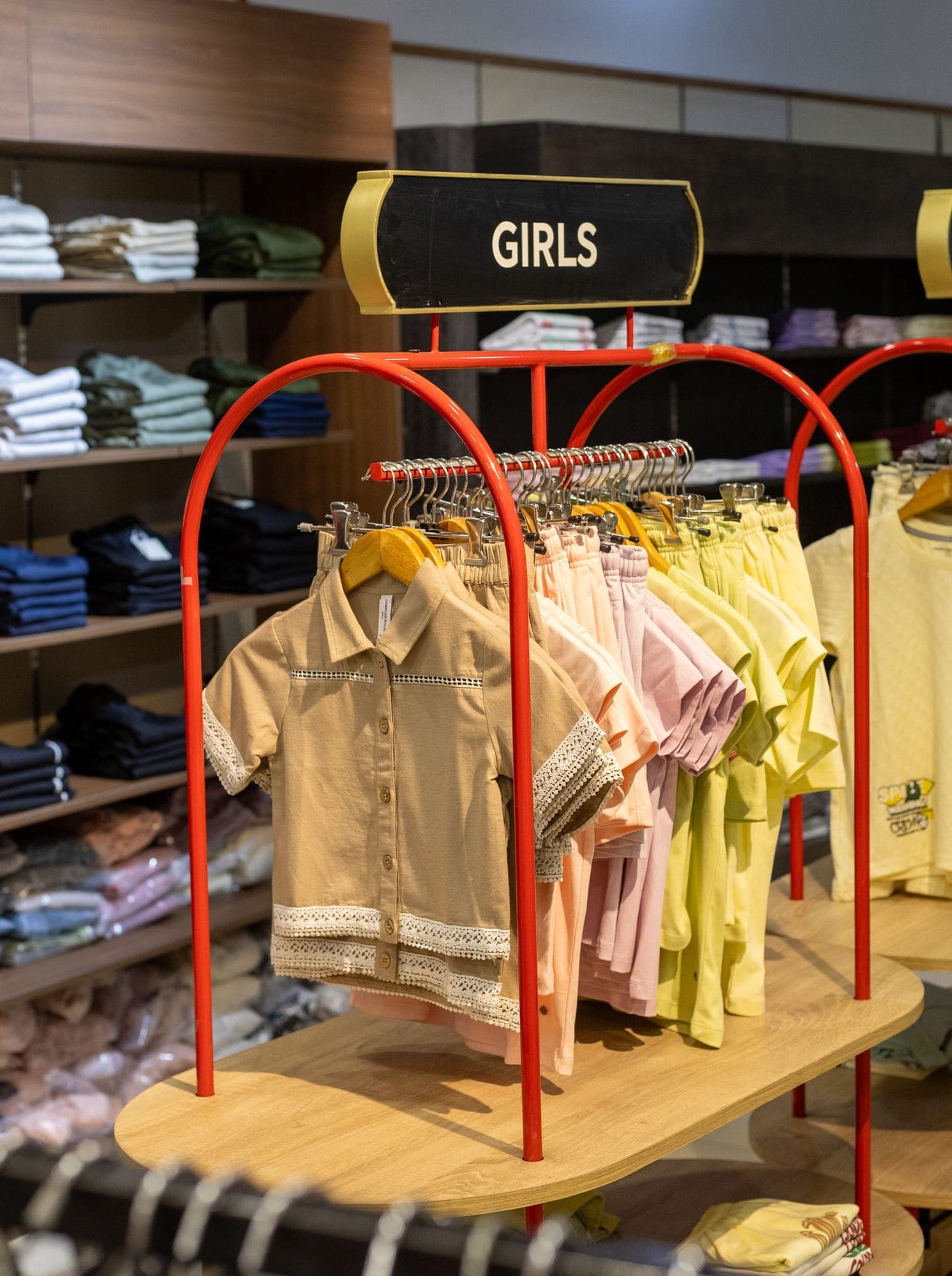The children's racks at K.A.K, Kohima, girls' and boys' sets on red arched rails