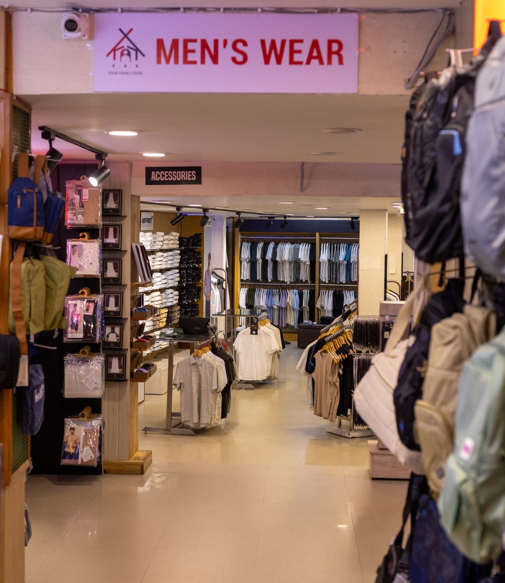 The entrance to the men's wear floor at K.A.K, Kohima, bags racked either side of the way in