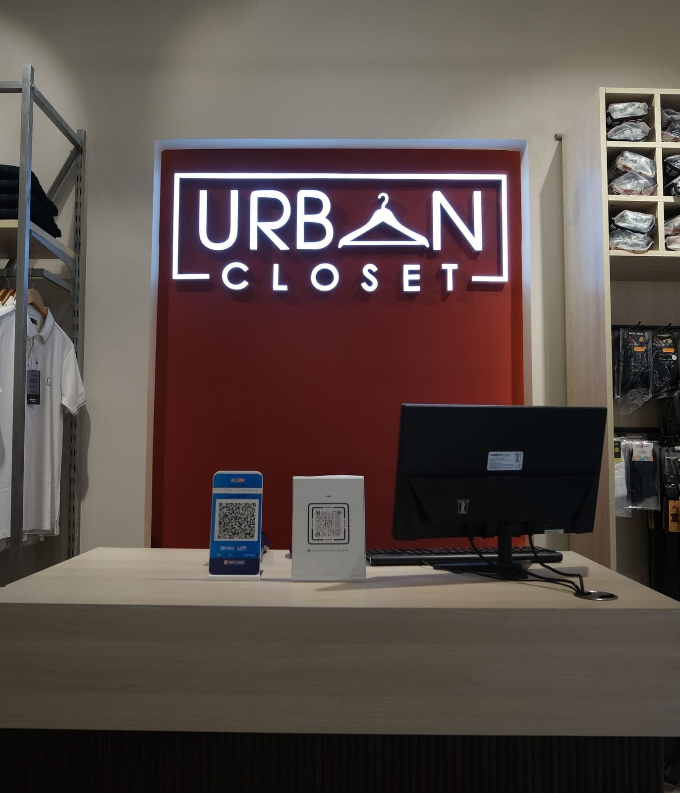 The counter at Urban Closet, Goalpara, under the store's lit sign