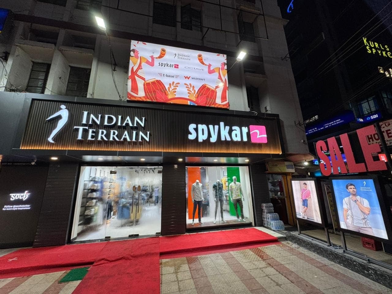 Urban Closet, Guwahati: the front at night, under its Indian Terrain and Spykar fascias.